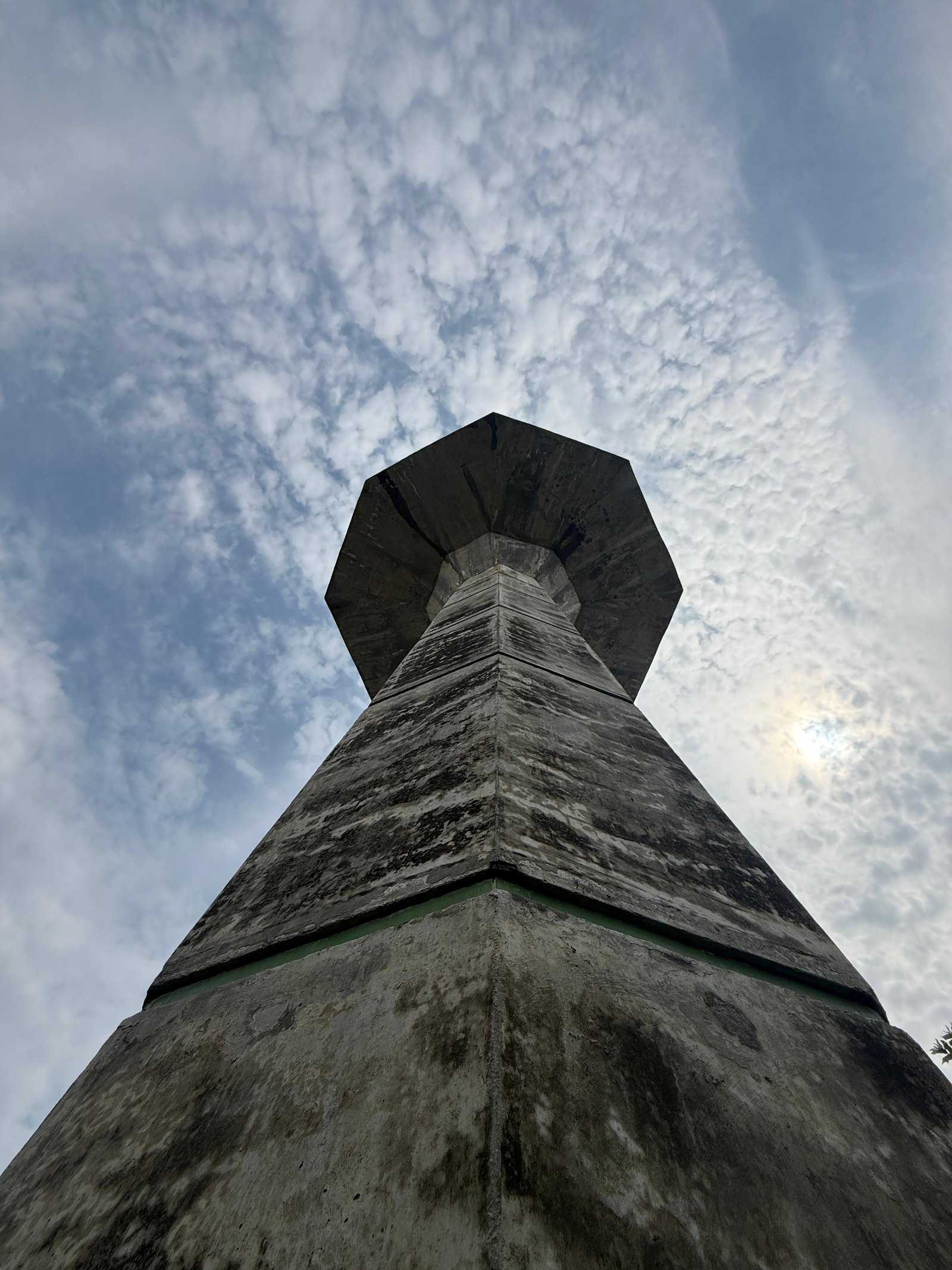 Concrete tower rising against a mackerel sky at Sharjah City Housing Scheme, Gujranwala